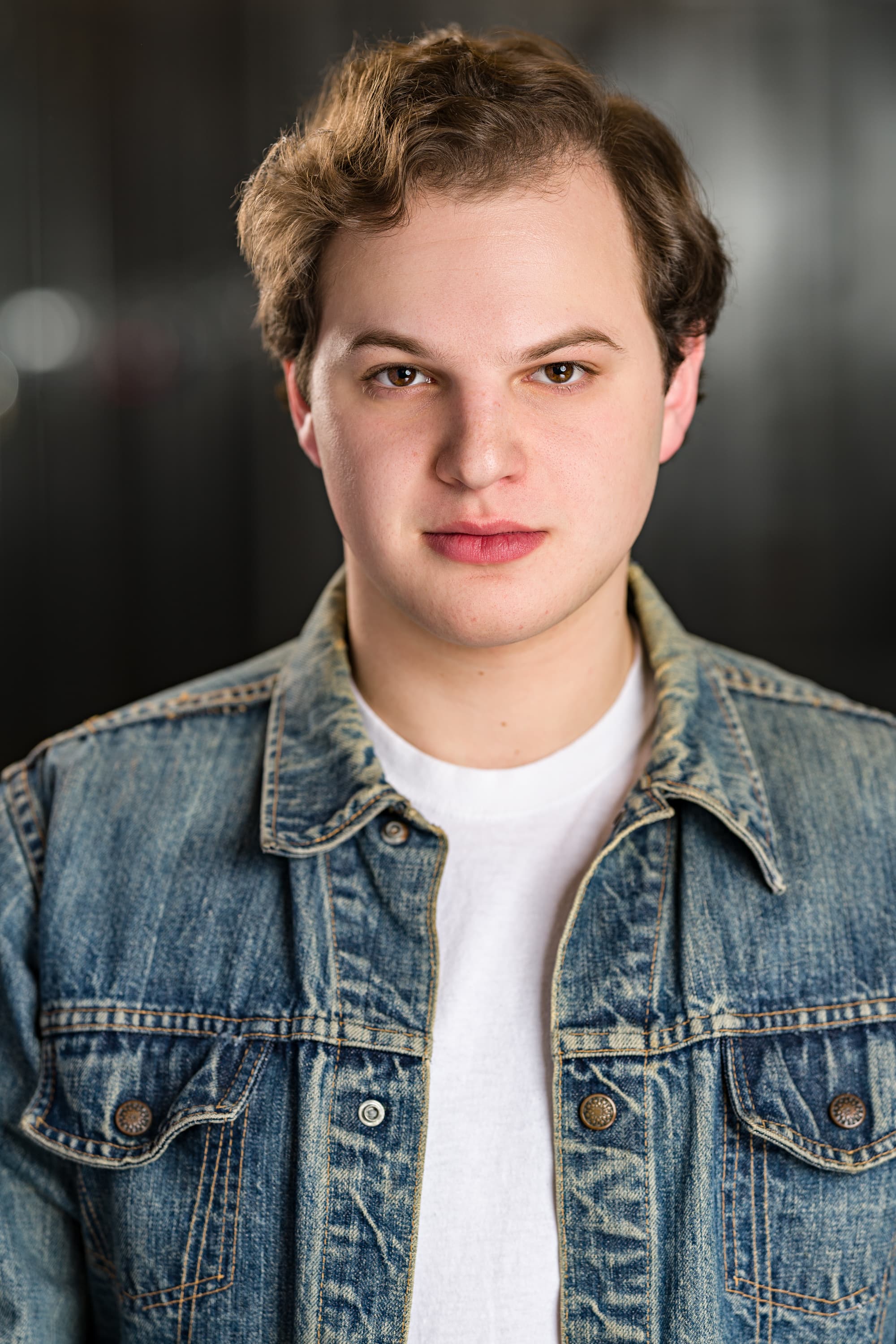 Jacob in denim jacket, smiling.